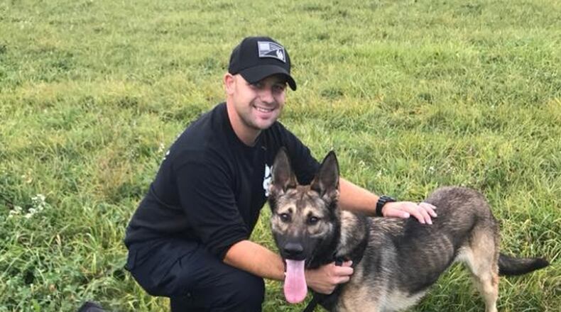 The Colerain Township newsletter posted this picture of Robert Brinkman and his K-9 partner, Tao, on Oct. 5, 2017. Brinkman, a Liberty Twp. resident, was indicted Thursday by a Butler County grand jury on sex charges involving a minor. (COURTESY/COLERAIN TWP.)
