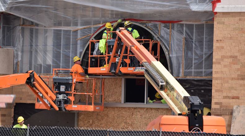 New Cutline: Dozens of stores have closed in the Dayton area over the past year, but area experts said the market is still healthy because the area is filling those locations. Danis construction works on the Sears box at the Mall at Fairfield Commons. STAFF PHOTO / HOLLY SHIVELY
