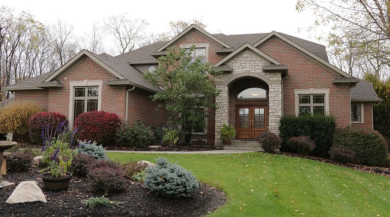 The brick 2-story has about 6,100 sq. ft. of living space. Additional living space was added when the sunroom was converted to a 4-season room and an unfinished bonus room was transitioned into an exercise room. The 4-bedroom home has a walk-out lower level and an attached, 3-car garage. CONTRIBUTED PHOTO BY KATHY TYLER