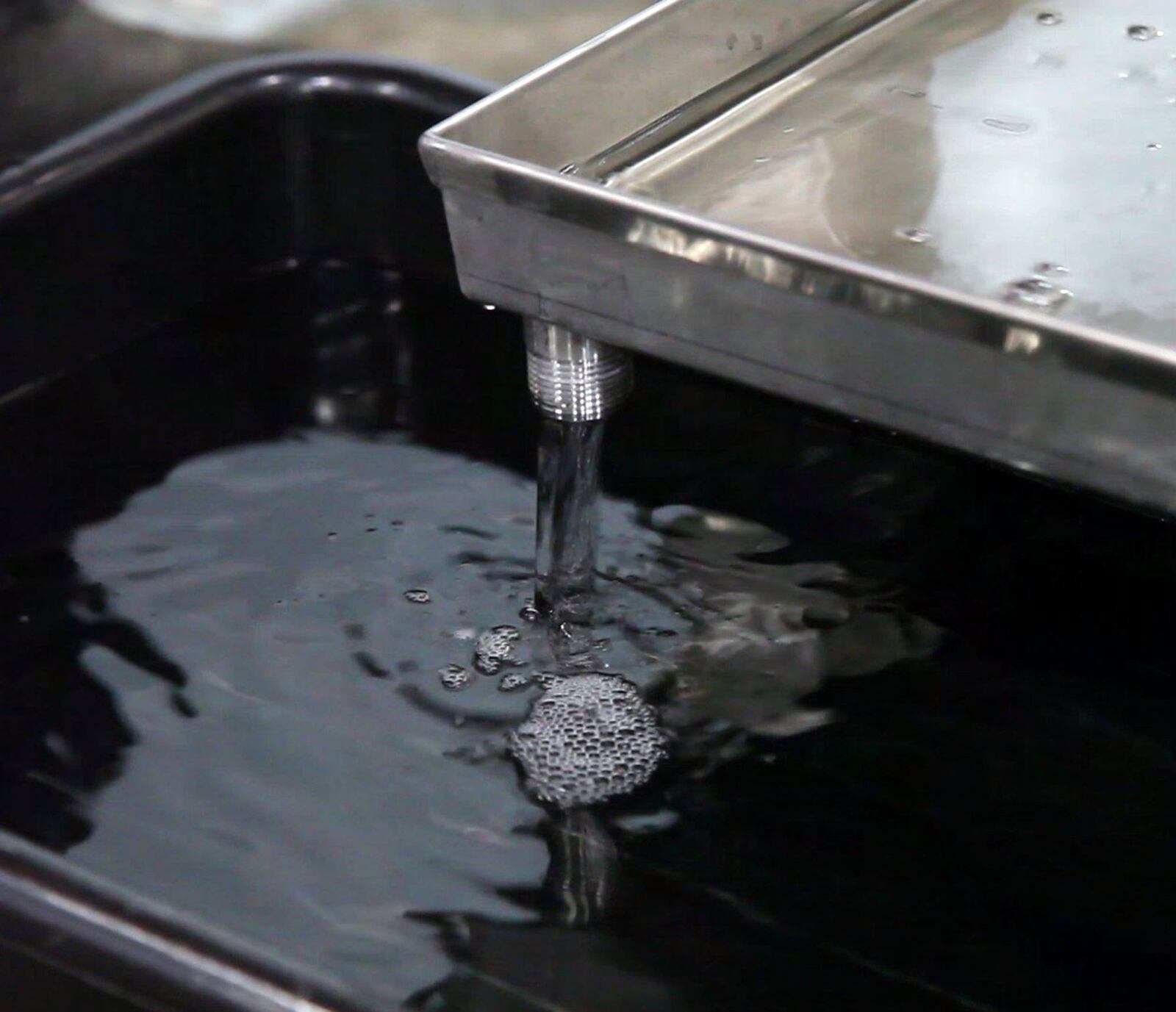 Freshly distilled and filtered Buckeye Vodka flows into a container at the Dayton distillery and warehouse.