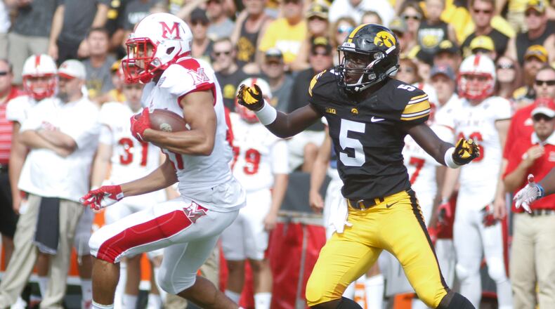 IOWA CITY, IOWA- SEPTEMBER 3: Running back Maurice Thomas #31 of the Miami (OH) RedHawks breaks a tackle by defensive back Manny Rugamba #5 of the Iowa Hawkeyes during the second quarter on September 3, 2016 at Kinnick Stadium in Iowa City, Iowa. (Photo by Matthew Holst/Getty Images)