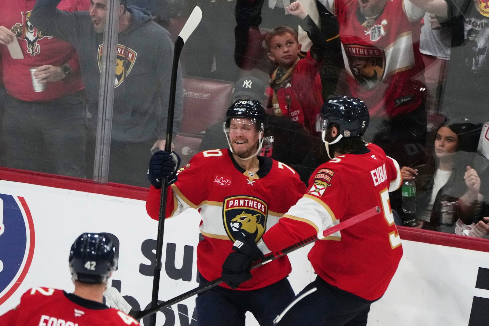 Florida Panthers center Jesper Boqvist, left, reacts after scoring a goal against the Carolina Hurricanes during the third period in Game 3 of the NHL hockey Stanley Cup Eastern Conference finals Saturday, May 24, 2025, in Sunrise, Fla. (AP Photo/Lynne Sladky)