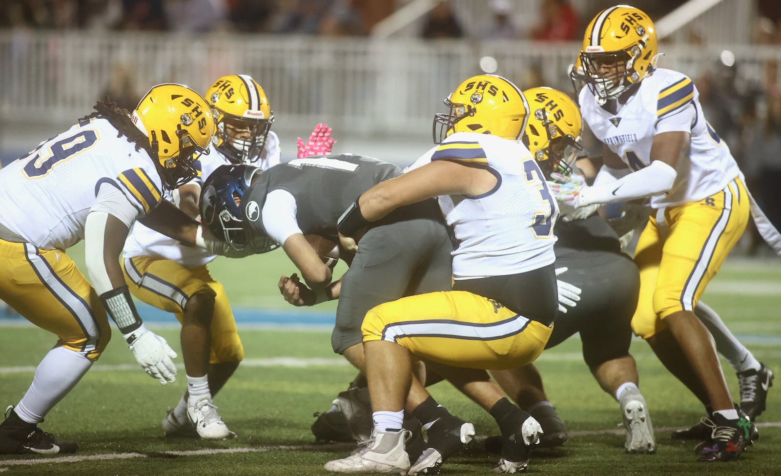 Springfield's Preston Allen tackles Fairmont's Reagan Heffner on Friday, Oct. 17, 2025, at Roush Stadium in Kettering. David Jablonski/Staff