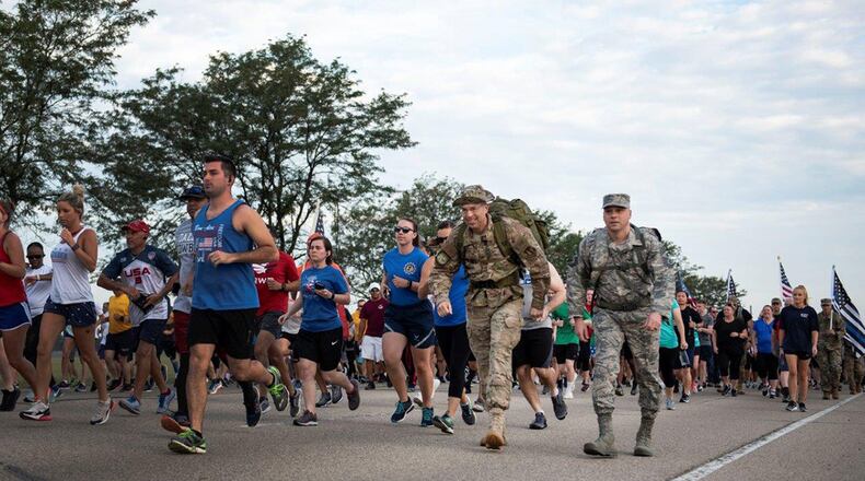 Runners, including Col. Thomas P. Sherman (center), 88th Air Base Wing and installation commander, and Chief Master Sgt. Stephen Arbona, 88th Air Base Wing command chief, take off at the start of the Wright-Patterson Air Force Base Run for the Fallen Sept. 11. The event was held to mark the 18th anniversary of the 9/11 terrorist attacks. (U.S. Air Force photos/Michelle Gigante)