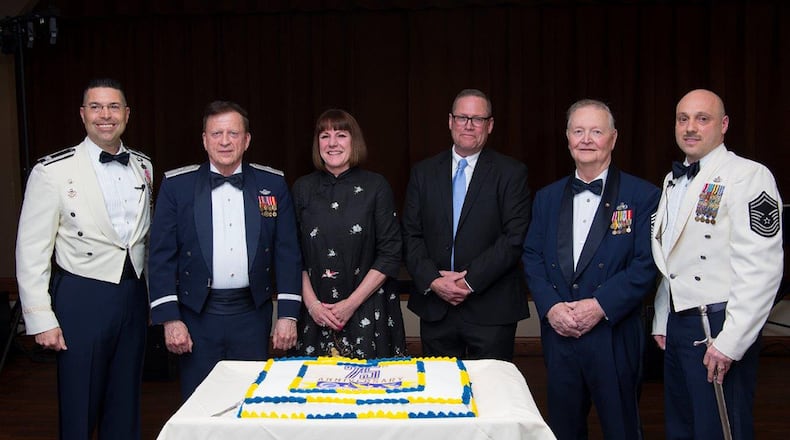 Col. Thomas Sherman, 88th Air Base Wing and installation commander; retired Brig. Gen. Charles E. Fox Jr, 2750th Air Base Wing commander, June 1984-March 1987; retired Col. Colleen M. Ryan, 88th ABW commander, June 2006-July 2008; retired Chief Master Sgt. Kent Smith, 88th ABW command chief, June 2006-2009; retired Chief Master Sgt. Roger Sloan, 2750th ABW senior enlisted advisor, 1987-1989; and Chief Master Sgt. Stephen Arbona, current 88th ABW command chief; pose April 26 with a ceremonial cake marking the 75th anniversary of the air base wing at Wright-Patterson Air Force Base. The air base wing went through various name changes, including changing from the 2750th to the 645th in 1992, and then becoming the 88th in 1994. (U.S. Air Force photo/R.J. Oriez)