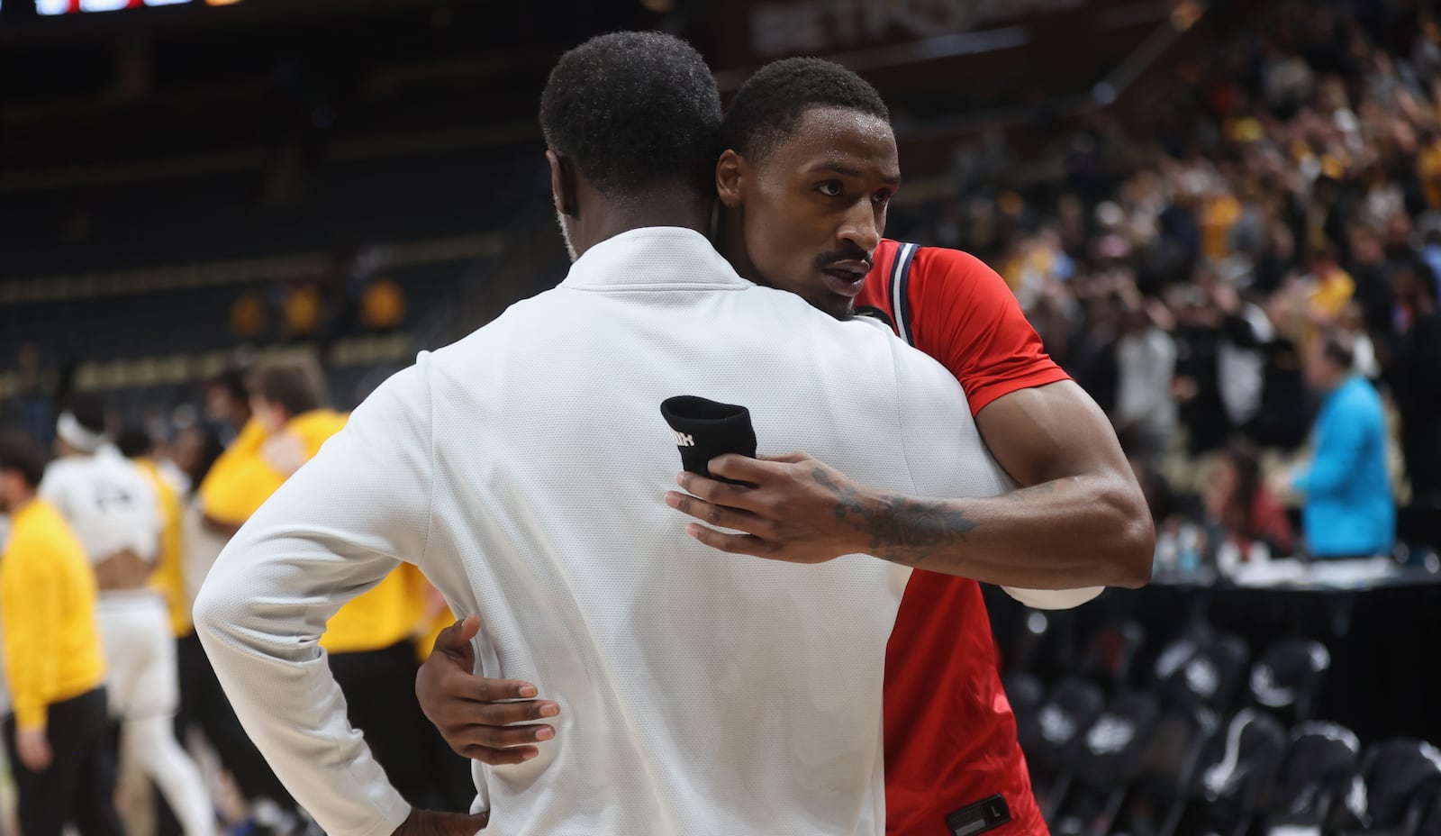 Dayton's Keonte Jones, back, hugs Anthony Grant after a loss to Virginia Commonwealth in the Atlantic 10 Conference championship game on Sunday, March 15, 2026, at PPG Paints Arena in Pittsburgh. David Jablonski/Staff