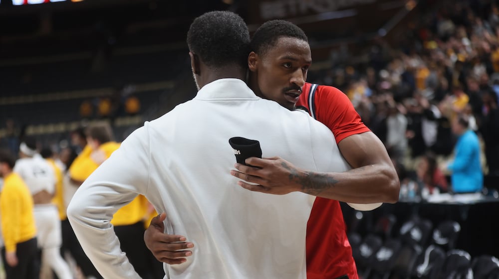 Dayton's Keonte Jones, back, hugs Anthony Grant after a loss to Virginia Commonwealth in the Atlantic 10 Conference championship game on Sunday, March 15, 2026, at PPG Paints Arena in Pittsburgh. David Jablonski/Staff