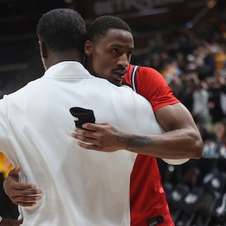 Dayton's Keonte Jones, back, hugs Anthony Grant after a loss to Virginia Commonwealth in the Atlantic 10 Conference championship game on Sunday, March 15, 2026, at PPG Paints Arena in Pittsburgh. David Jablonski/Staff