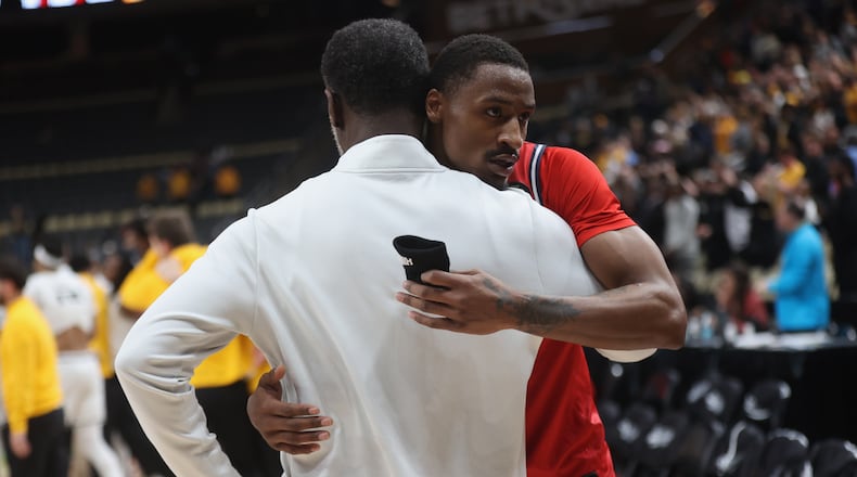 Dayton's Keonte Jones, back, hugs Anthony Grant after a loss to Virginia Commonwealth in the Atlantic 10 Conference championship game on Sunday, March 15, 2026, at PPG Paints Arena in Pittsburgh. David Jablonski/Staff