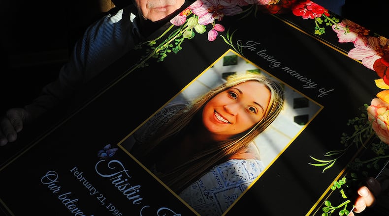 Ron Smith, of Patterson Park, holds a photo of his daughter Tristin Kate Smith, 28, of Dayton, who died by suicide on Aug. 7, 2023. Smith and others have shared a letter written by Tristin that he found on her laptop after her passing, which detailed a difficult working environment in the health care industry. MARSHALL GORBY\STAFF