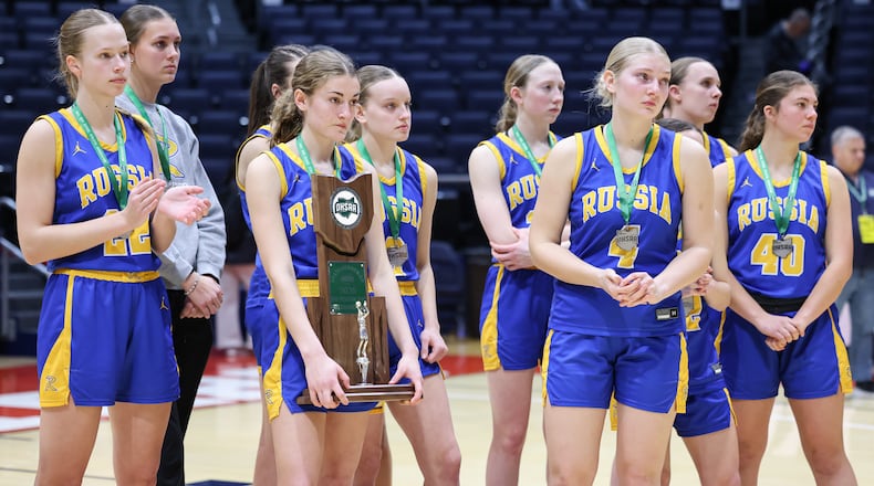 Russia players watch as Strasburg-Franklin players accept individual medals after a 38-17 loss in the Division VII state final on Saturday, March 14 at University of Dayton Arena. Russia, which earned its first state berth, finishes 25-4. BRYANT BILLING / STAFF