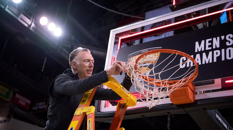Wright State Athletic Director Bob Grant snips a piece of the net after the Raiders' men's basketball team defeated Northern Kentucky in the Horizon League Championship game on March 8, 2022. Joe Craven/Wright State Athletics