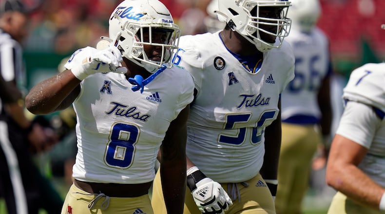 Tulsa running back Deneric Prince (8) celebrates his touchdown against South Florida with offensive lineman Tyler Smith during the first half of an NCAA college football game Saturday, Oct. 16, 2021, in Tampa, Fla. (AP Photo/Chris O'Meara)