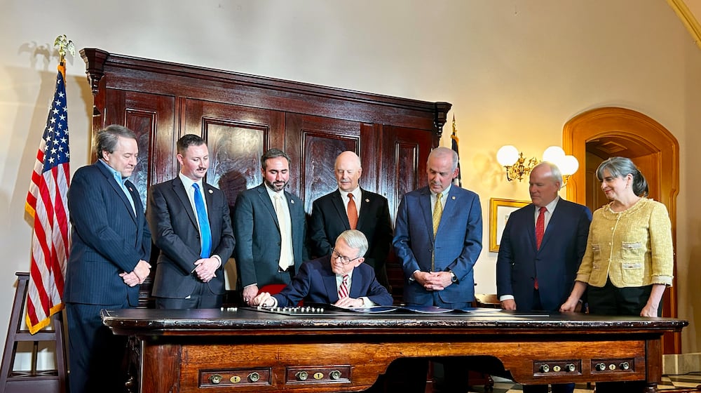Ohio Gov. Mike DeWine signs a series of bills meant to address rising property taxes in Ohio on Dec. 19, 2025. Photo by Avery Kreemer.