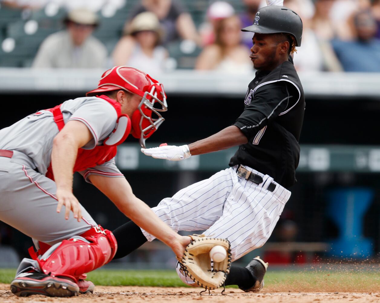 PHOTOS: Reds pile up 13 hits, beat the Rockies