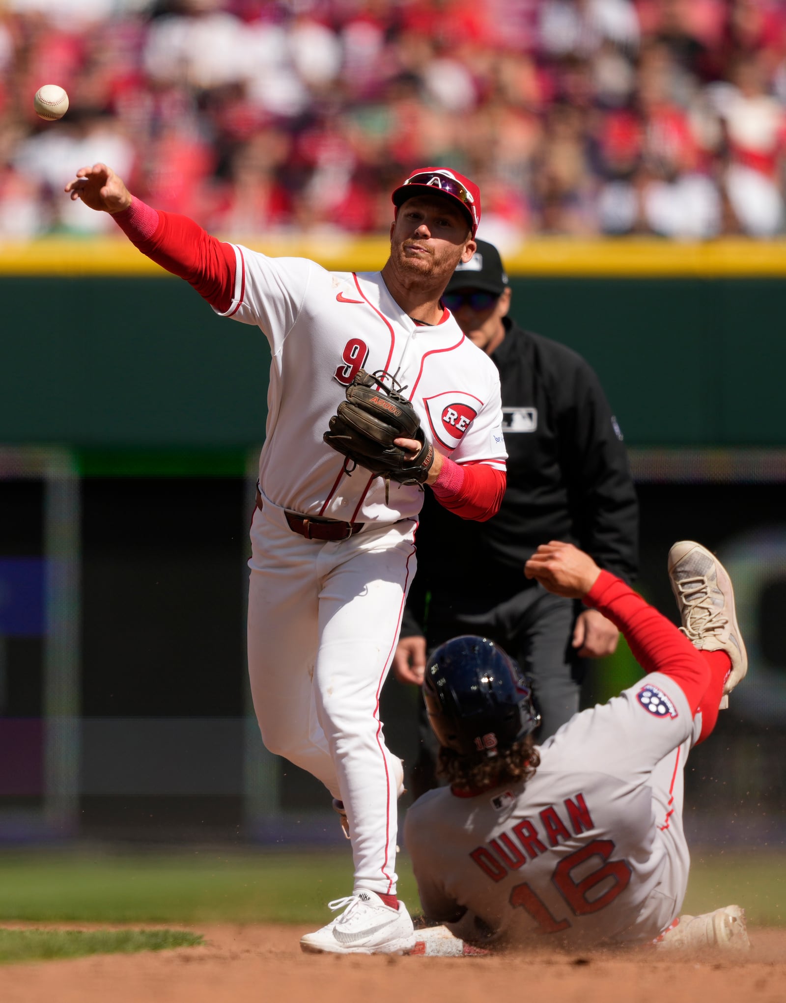 Boston Red Sox's Jarren Duran (16) is out at second base as Cincinnati Reds second baseman Matt McLain (9) throws to first base for the double play during the sixth inning of a baseball game in Cincinnati, Sunday, March 29, 2026. (AP Photo/Carolyn Kaster)