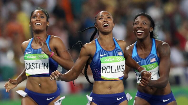 Gold medal winner Brianna Rollins, center, silver medal winner, Nia Ali, right, and bronze medal winner Kristi Castlin, all from the United States, pose with their country's flag after the 100-meter hurdles final,during the athletics competitions of the 2016 Summer Olympics at the Olympic stadium in Rio de Janeiro, Brazil, Wednesday, Aug. 17, 2016. (AP Photo/Lee Jin-man)