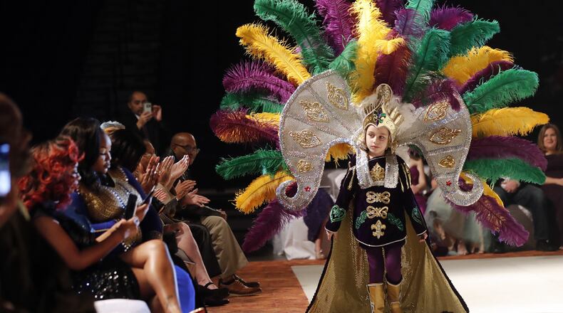 Jack Spittler III, a member of the royal court, walks for the audience at the Little Rascals Mardi Gras Ball in Kenner, La., Thursday, Jan. 25, 2018. (AP Photo/Gerald Herbert)