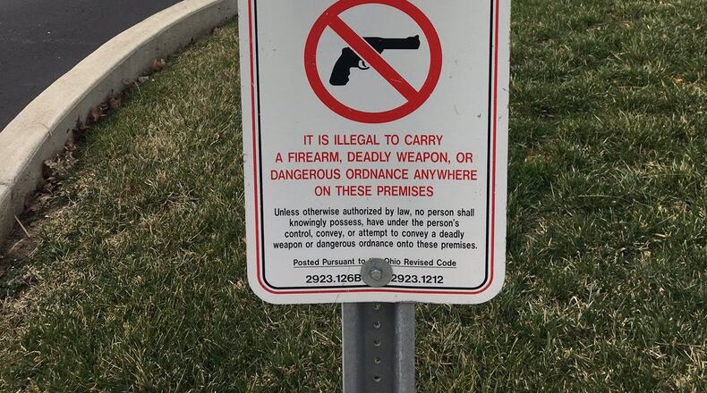 Beginning on March 21 companies will no longer be able to ban people with concealed carry permits from bringing handguns into company parking lots. The guns must remain stored inside a locked car. This sign and two others were removed in February from the parking lot entrance of Premier Health Fidelity Health Care at 3170 Kettering Blvd. LYNN HULSEY/Staff Writer