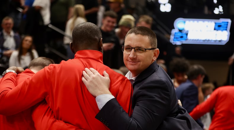 Dayton's Neil Sullivan celebrates with Anthony Grant after a victory against Nevada in the first round of the NCAA tournament on Thursday, March 21, 2024, at the Delta Center in Salt Lake City, Utah. David Jablonski/Staff