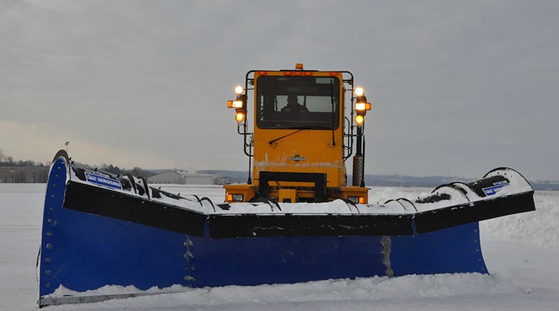 A snow plow clears the runway at Wright-Patterson Air Force Base in this file photo. Severe weather events like a snowstorm can wreak havoc on runways and streets on the installation, causing reporting delays or base closures. (U.S. Air Force photo)