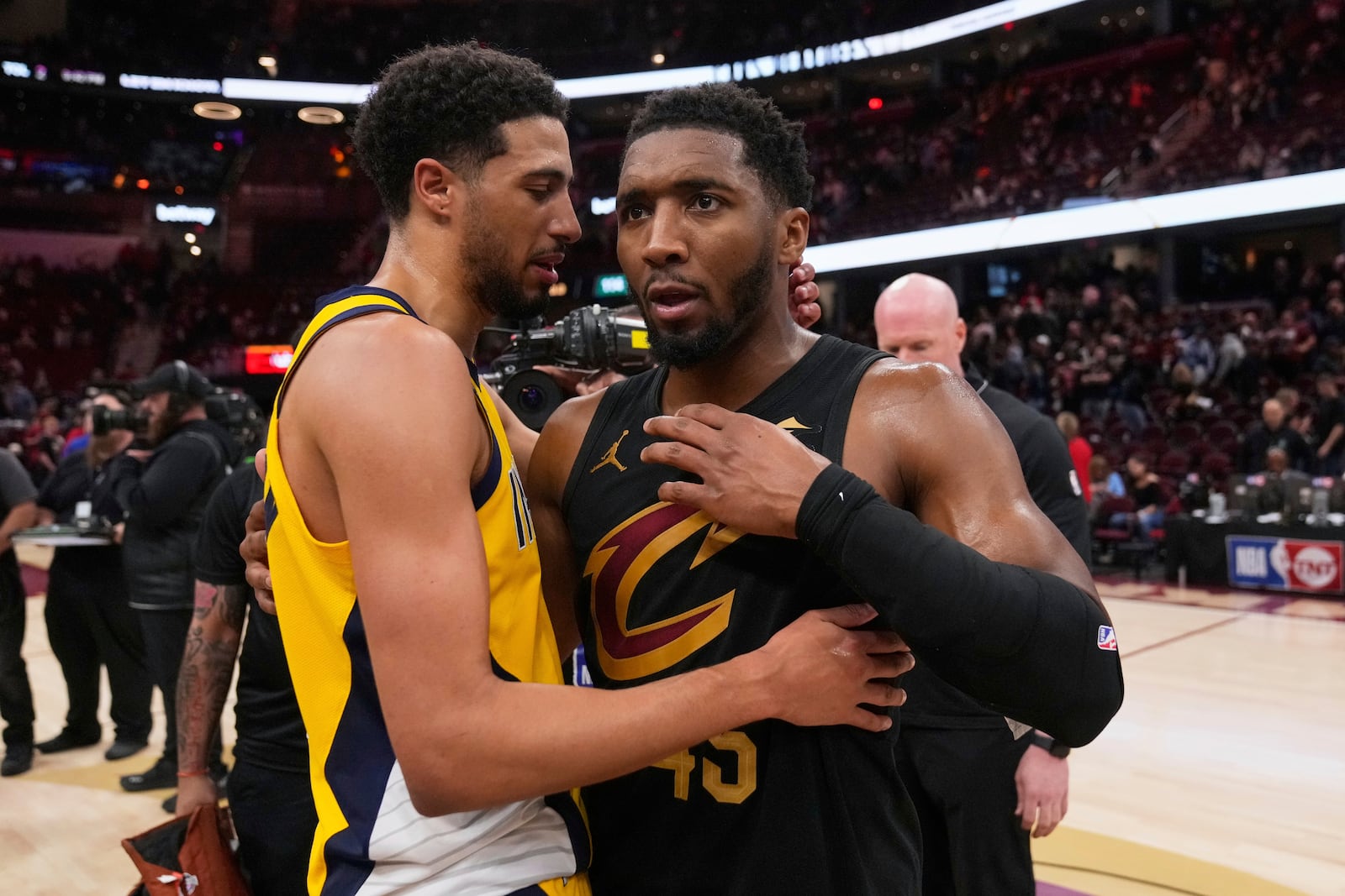 Indiana Pacers guard Tyrese Haliburton, left, and Cleveland Cavaliers guard Donovan Mitchell greet each other after the Pacers defeated the Cleveland Cavaliers 114-105 in Game 5 of an Eastern Conference semifinal NBA basketball playoff Tuesday, May 13, 2025, in Cleveland. (AP Photo/Sue Ogrocki)