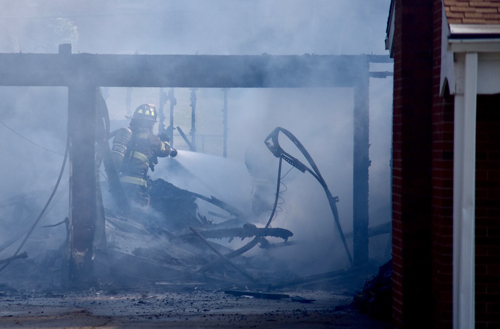 Firefighters work to extinguish a fire inside a detatched garage in Middletown Wednesday monring. Crews were dispatched at 8:40 a.m. to a garage engulfed in flames. NICK GRAHAM/STAF