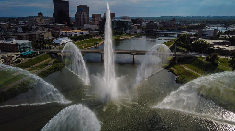 The downtown Dayton skyline is seen through the fountain spray Sept. 3, 2021, at Deeds Point MetroPark on Webster Street. JIM NOELKER/STAFF