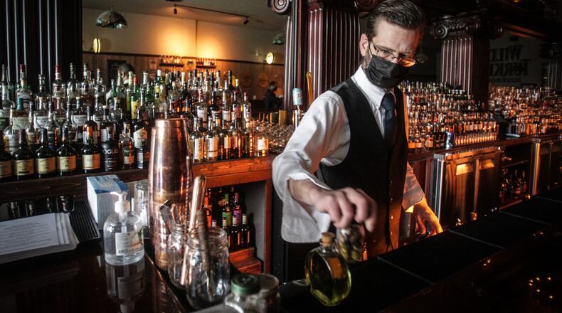 Century Bar barkeep, Mark Pittman, readying the bar for the first Friday night without a curfew. Jim Noelker/Staff