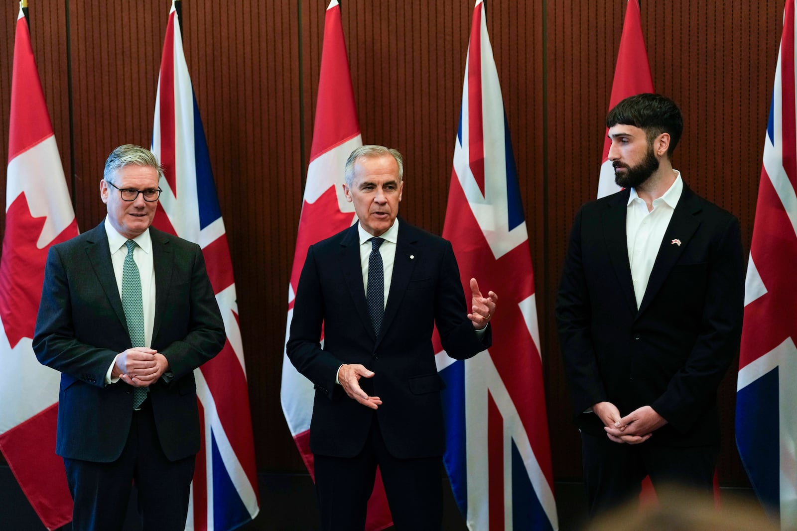 Prime Minister of Canada Mark Carney, centre, and Prime Minister of the United Kingdom Keir Starmer, left, meet with Aidan Gomez, CEO of AI startup Cohere, in Ottawa on Sunday, June 15, 2025. (Justin Tang/The Canadian Press via AP)