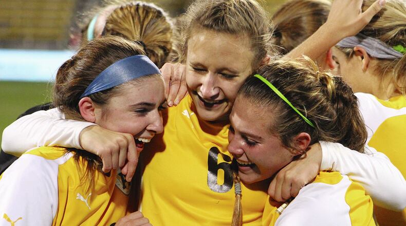 From left, Alter’s Grace Haines, Ashley Maples and Lauren Dietz celebrate the school’s first girls soccer state title. The Knights beat Chagrin Falls 3-0 in the Division II final Saturday night at MAPFRE Stadium in Columbus. Jeff Gilbert / Contributed photo