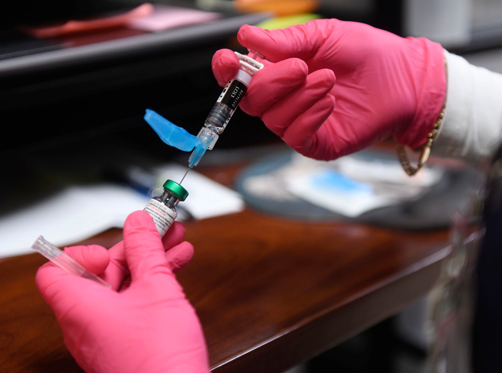 Anna Hicks prepares a measles, mumps and rubella vaccine at the Andrews County Health Department, Tuesday, April 8, 2025, in Andrews, Texas. (AP Photo/Annie Rice)