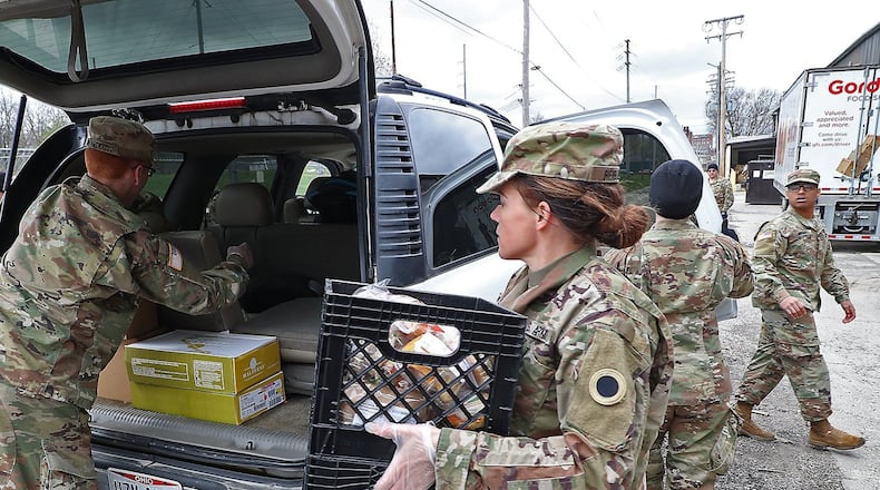 Ohio National Guard members based in Springfield helped distributed food during the coronavirus pandemic at the Second Harvest Food Bank as a line of cars, waiting for food, wrapped around the food bank.