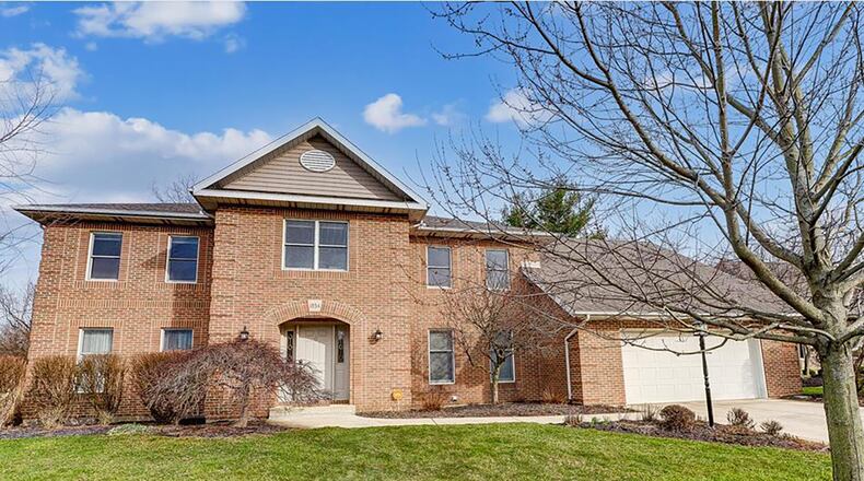The front of the brick two-story has a covered entry, concrete driveway and two-car attached garage with opener. Contributed photos