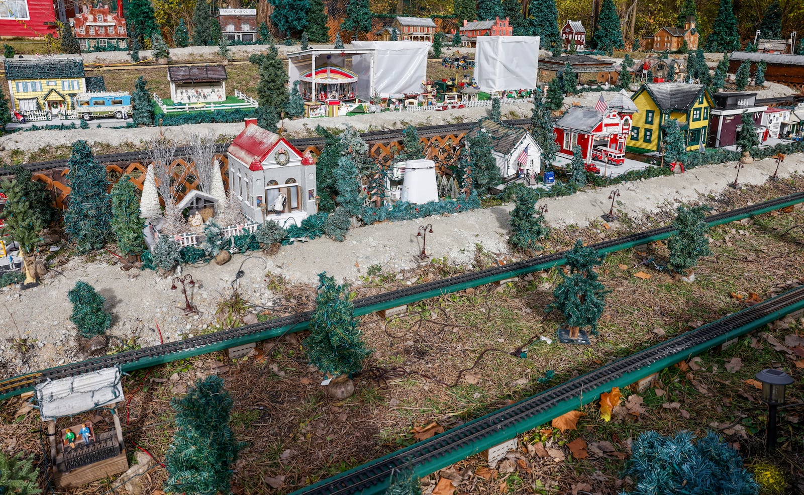 Homes, trees and other Christmas decorations surround a small train track on Monday, November 24, 2025, at Clifton Mill. JOSEPH COOKE/STAFF