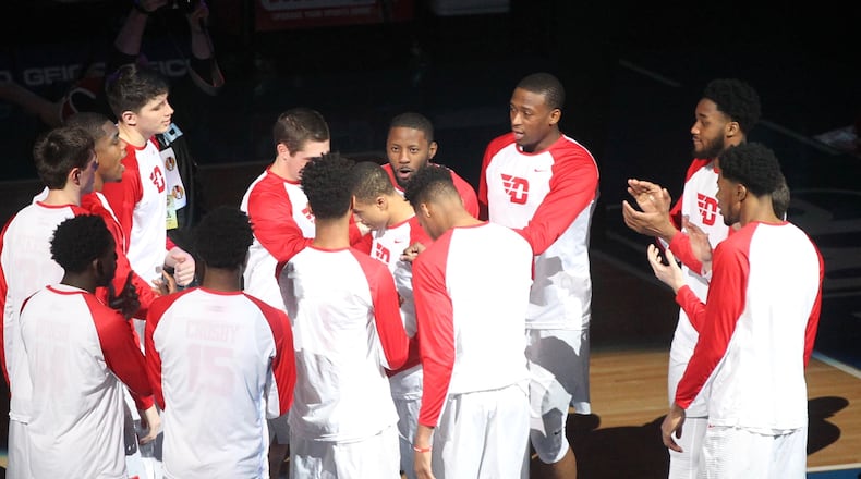 Dayton players huddle before a game against Davidson on Friday, March 10, 2017, at PPG Paints Arena in Pittsburgh. David Jablonski/Staff