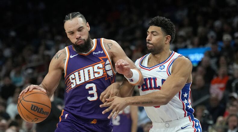 Phoenix Suns forward Dillon Brooks (3) dribbles the ball against Philadelphia 76ers guard Quentin Grimes during the second half of an NBA basketball game Saturday, Feb. 7, 2026, in Phoenix. (AP Photo/Ross D. Franklin)