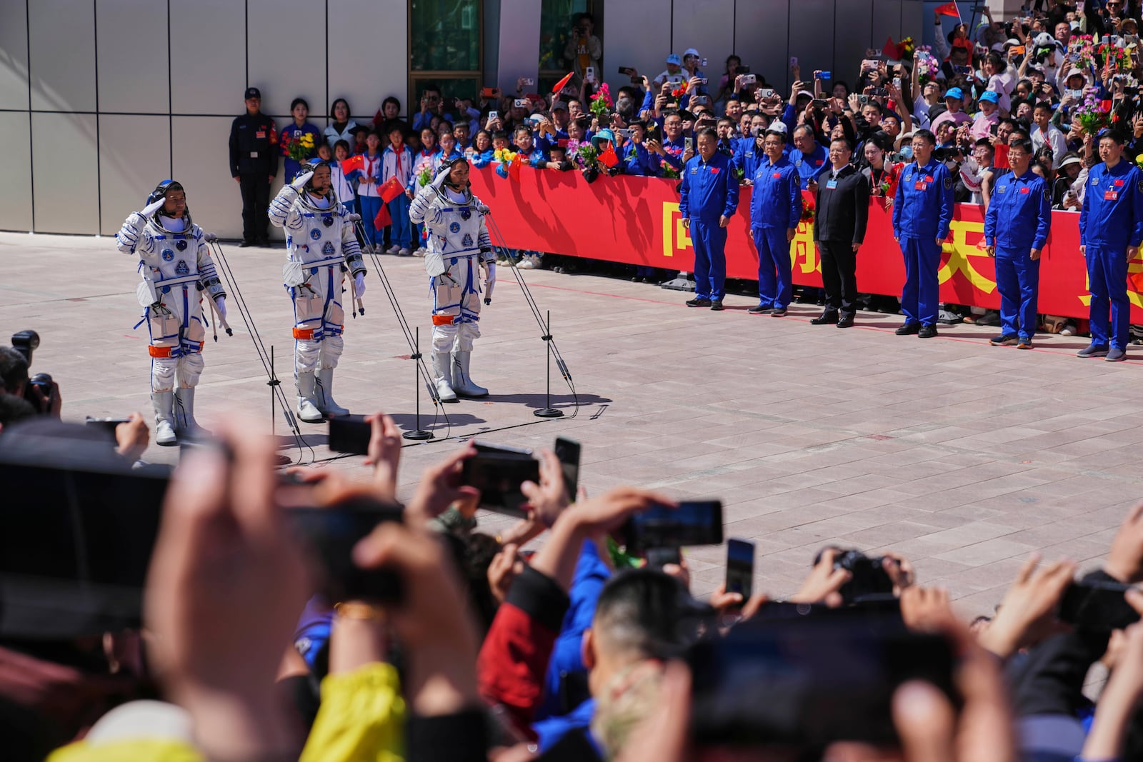 Chinese astronauts for the Shenzhou 20 mission, from right, Chen Zhongrui, Chen Dong and Wang Jie salute as they attend a send-off ceremony for their manned space mission at the Jiuquan Satellite Launch Center in northwestern China, Thursday, April 24, 2025. (AP Photo/Andy Wong)