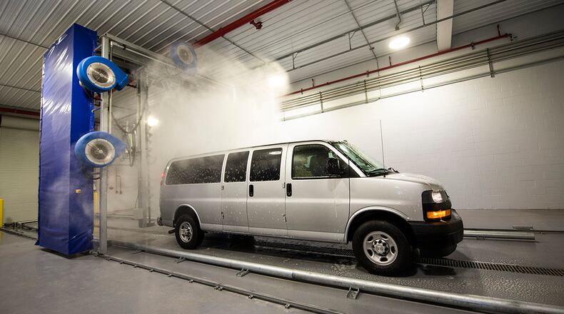 A government-operated vehicle gets washed on Oct. 5 by new automated official vehicle carwash located in Bldg. at Wright-Patterson Air Force Base. The new energy-efficient carwash recycles the water used, making it more energy efficient and environmentally friendly. (U.S. Air Force photo by Hannah Carranza)