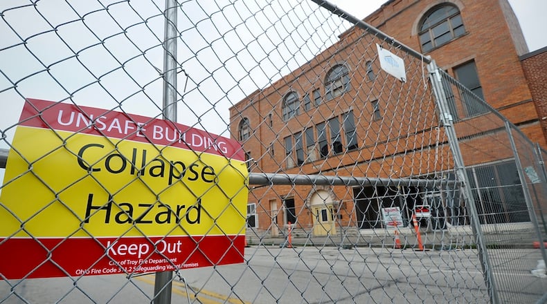 The 100 block of West Main Street in Troy is completely blocked off June 27, 2023, after city officials declared the controversial Tavern building there unsafe. MARSHALL GORBY \STAFF