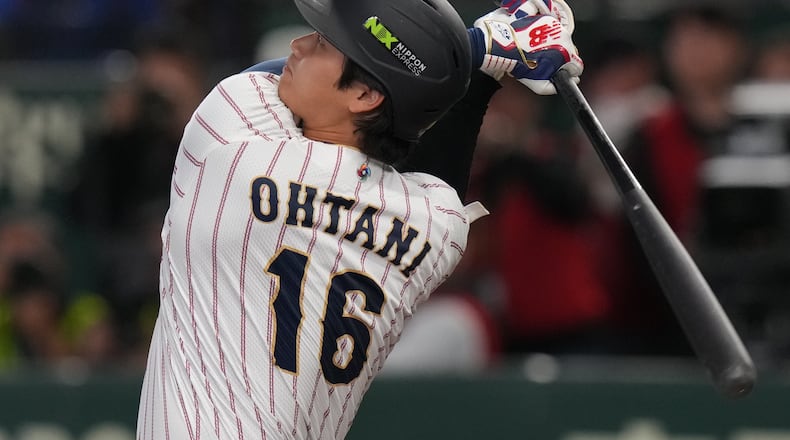 Japan's Shohei Ohtani hits a home run during the third inning of a World Baseball Classic game between Japan and South Korea on Saturday, March 7, 2026 in Tokyo, Japan. (AP Photo/Eugene Hoshiko)