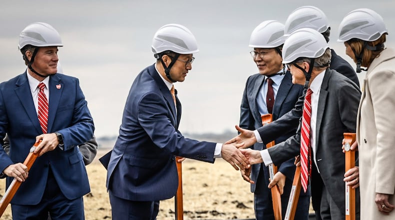 JV company CEO, Robert Lee, left center,  shakes the hand of Ohio Gov. Mike DeWine after the groundbreaking of the new EV battery plant near Jeffersonville on Feb. 28, 2023. JIM NOELKER/STAFF
