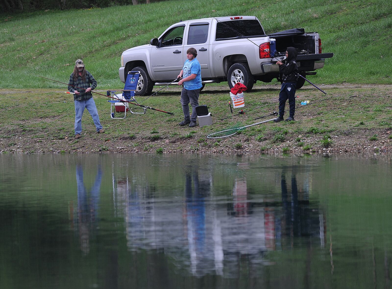 People come to Rainbow Lakes in Fairborn to relax and fish on Wednesday, April 10, 2024. MARSHALL GORBY\STAFF