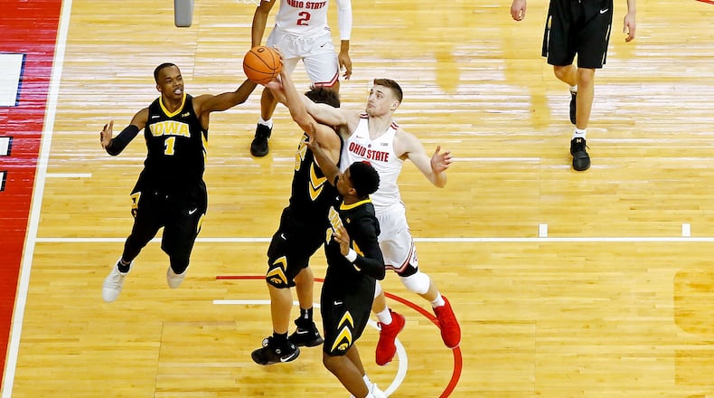 COLUMBUS, OH - FEBRUARY 10:  Maishe Dailey #1 of the Iowa Hawkeyes and Micah Potter #0 of the Ohio State Buckeyes compete for a rebound during the game at Value City Arena on February 10, 2018 in Columbus, Ohio. Ohio State defeated Iowa 82-64. (Photo by Kirk Irwin/Getty Images)