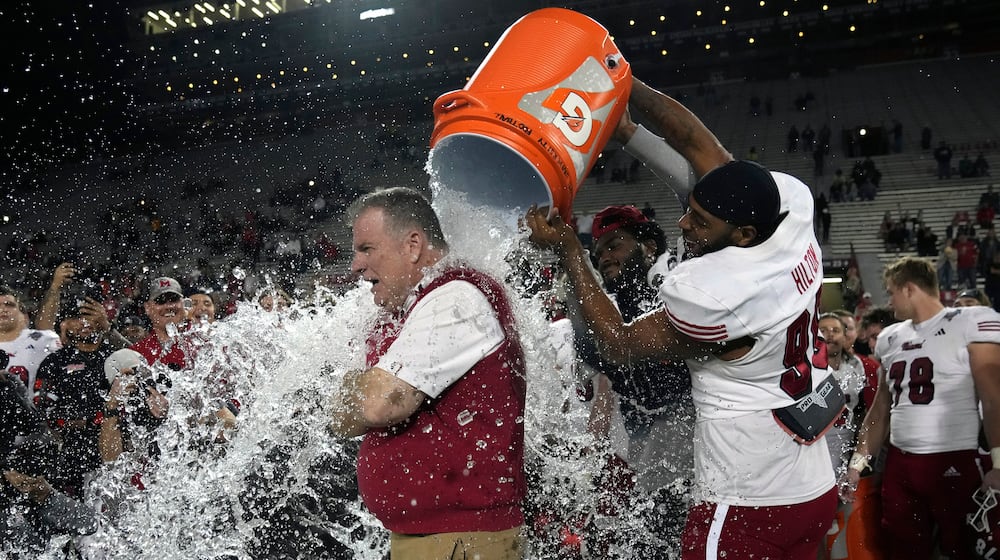 Miami (Ohio) defensive lineman Kobe Hilton, front right, douses head coach Chuck Martin, front left, after they defeated Colorado State in the Arizona Bowl NCAA college football game, Saturday, Dec. 28, 2024, in Tucson, Ariz. (AP Photo/Rick Scuteri)