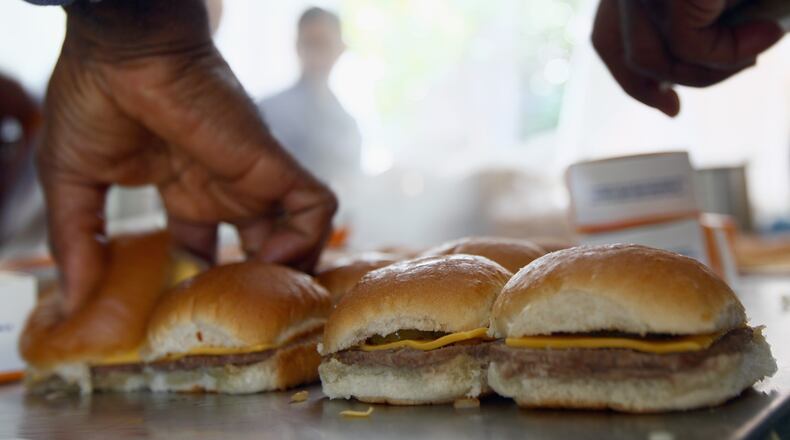 WASHINGTON, DC - JUNE 14:  White Castle employees cook their slider burgers before delivering them at the U.S. Capitol to celebrate the company's 90th anniversary with a "Castles at the Capitol" event June 14, 2011 in Washington, DC. Representatives of the Columbus, Ohio-based company hand-delivered their slider burgers to waiting congressional employees during their lunch hour.  (Photo by Win McNamee/Getty Images)