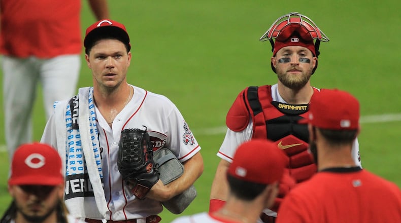 Reds pitcher Sonny Gray and catcher Tucker Barnhart return to the dugout after warming up before a game against the Indians on Monday, Aug. 3, 2020, at Great American Ball Park in Cincinnati.
