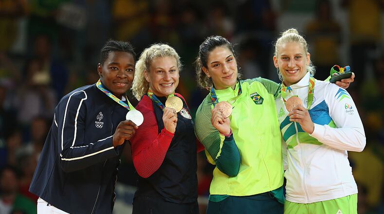 RIO DE JANEIRO, BRAZIL - AUGUST 11: Silver medalist Audrey Tcheumeo of France, gold medalist Kayla Harrison of the United States and bronze medalists Mayra Aguiar of Brazil and Anamari Velensek of Slovenia celebrate on the podium after the women’s -78kg judo contest on Day 6 of the 2016 Rio Olympics at Carioca Arena 2 on August 11, 2016 in Rio de Janeiro, Brazil. (Photo by Julian Finney/Getty Images)