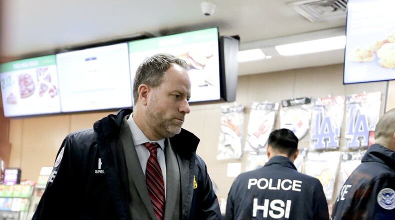 Christopher Kuemmerle, a group supervisor for U.S. immigration and Customs Enforcement’s Homeland Security Investigations unit watches as agents serve an employment audit notice at a 7-Eleven convenience store Wednesday, Jan. 10, 2018, in Los Angeles. Agents said they targeted about 100 7-Eleven stores nationwide Wednesday to open employment audits and interview workers. (AP Photo/Chris Carlson)