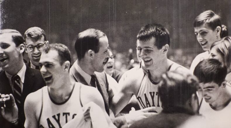 Dayton Flyers basketball. Guard Bob Hooper, coach Don Donoher, Don May and Dan Obrovac after game against North Carolina. Mar. 25, 1967. COURTESY OF WRIGHT STATE UNIVERSITY, DAYTON DAILY NEWS ARCHIVE